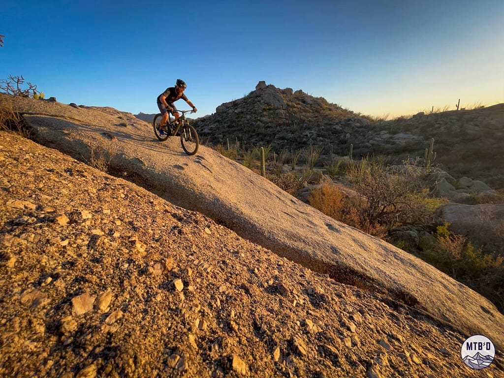 Mountain biking in Tucson on Upper 50 Year, sending a rock roll