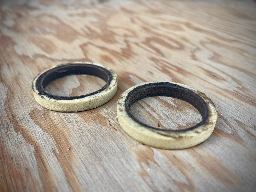 Dirt foam rings from a mountain bike suspension fork that was long overdue for a lowers service.